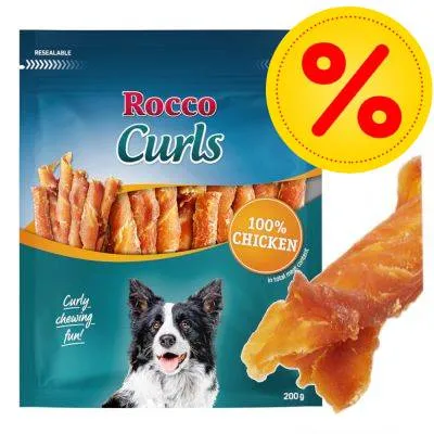 Rocco Curls, 100% Chicken, balení 200 g. Na obalu je pes a nápis Curly chewing fun! Zvýrazněná sleva symbolem procenta.