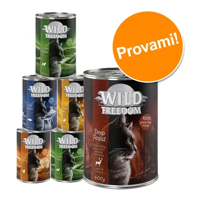 Scatolette Wild Freedom per gatti, vari gusti visibili: Deep Forest, Green Lands, Gold River, Golden Valley, Wide Country. Testo sull'etichetta: 100% grain-free recipe. Bollino arancione: Provami!