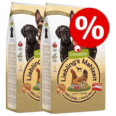 Two bags of GranataPet Liebling's Mahlzeit Puppy/Junior Geflügel/Poultry dry dog food with a red percentage discount symbol. Visible text: Made in Austria, Pomegranate seeds, Green-lipped mussel, Salmon oil.
