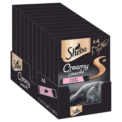 Sheba Creamy Snacks z lososom, paket 11 x 4 palčke po 12g, skupna teža 528g. Prikaz sive mačke in simbola hranjenja iz roke.