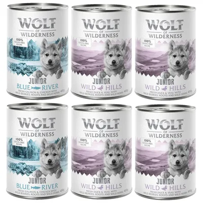 6 dåser Wolf of Wilderness Junior hundemad, varianter Blue River og Wild Hills, 400 g. Tekst: 100% grain-free recipe, fresh salmon & chicken eller fresh duck & veal med bær, rødder, urter.