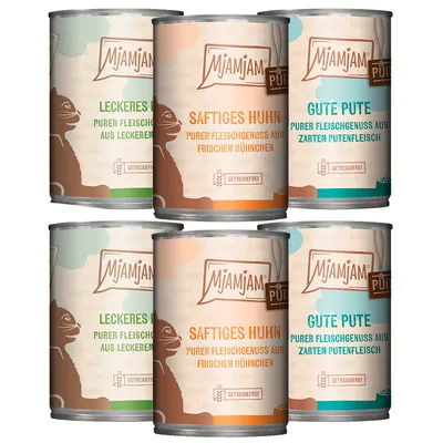 Latas de comida para gatos MjAMjAM. Textos visibles: 'LECKERES RIND', 'SAFTIGES HUHN', 'GUTE PUTE', 'GETREIDEFREI', 'PURER FLEISCHGENUSS AUS FRISCHEM HÜHNCHEN' en alemán. Latas de comida para gatos MjAMjAM. Textos visibles: 'LECKERES RIND', 'SAFTIGES HUHN', 'GUTE PUTE', 'GETREIDEFREI', 'PURER FLEISCHGENUSS AUS FRISCHEM HÜHNCHEN' en alemán.