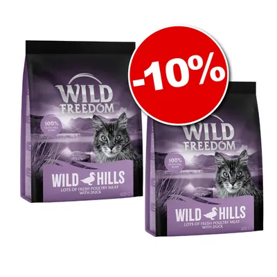 Două pungi de hrană pentru pisici Wild Freedom Wild Hills, 400 g, cu text vizibil „100% grain-free recipe” și etichetă promoțională roșie cu -10%.