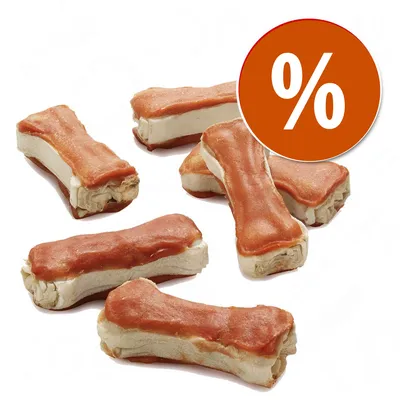 Snack em forma de osso com cobertura castanha, vários exemplares visíveis. Círculo laranja com símbolo de percentagem (%) indica promoção ou desconto.