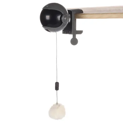 Toy holder with black ball, clamp for attaching to table edge and dangling white plush ball on string.