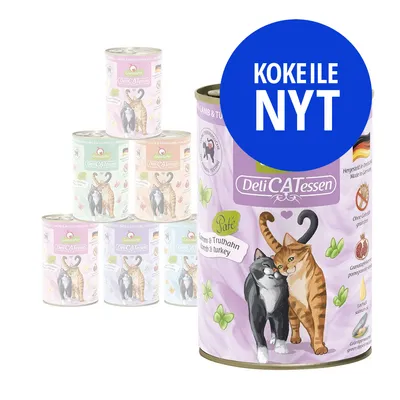 DeliCATessen kissan märkäruokapurkkeja eri makuja, etiketissä kaksi kissaa. Suuri sininen ympyrä: KOKEILE NYT. Maku: Lammas & kalkkuna. Näkyvissä saksalainen lippu.