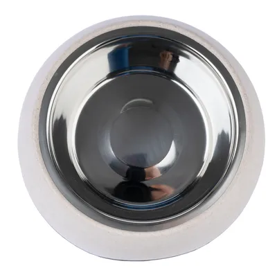 Round stainless steel feeding bowl with white ceramic frame, suitable for pets.