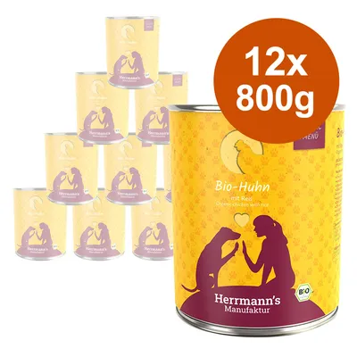 Herrmann's Manufaktur Bio-Huhn mit Reis, 12 konzervi po 800 g. Tekst na pakiranju: Organic chicken with rice, Bio certifikat. Prikaz limenki s motivom psa i osobe.