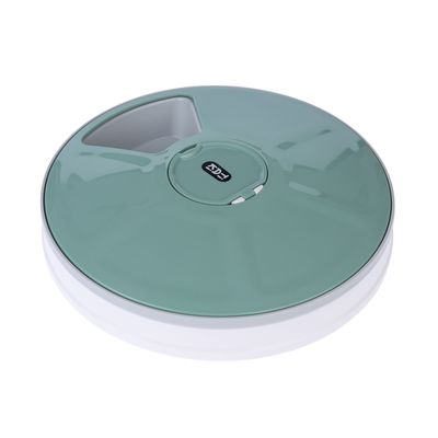 Runder, grüner Futterautomat mit Fachöffnung und Eyenimal-Logo auf der Oberseite.