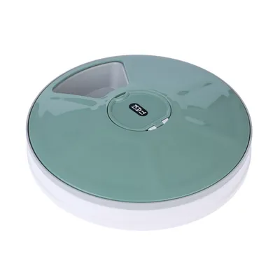 Dispenser de hrană rotund, verde, cu deschidere pentru compartiment și logo Eyenimal pe partea superioară.