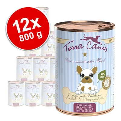 Pack de 12 latas de 800 g de Terra Canis para perros. Texto visible: 'Lamm mit Zucchini, Fenchel & Mageryoghurt', '100 % Natur', 'Puppy-Menu: Lamb with courgette, fennel & low fat yoghurt'. Pack de 12 latas de 800 g de Terra Canis para perros. Texto visible: 'Lamm mit Zucchini, Fenchel & Mageryoghurt', '100 % Natur', 'Puppy-Menu: Lamb with courgette, fennel & low fat yoghurt'.