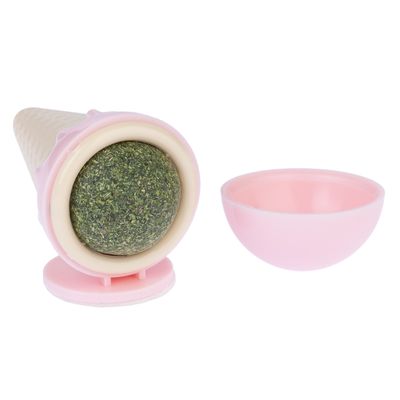 Игрушка в форме вафельного рожка с зеленым шариком из трав и съемной розовой крышкой.