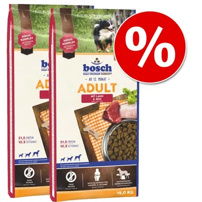 Dva pakiranja Bosch Adult mit Lamm & Reis pseće hrane, 15 kg, s natpisima: 21,5 % proteina, 10,5 % fetthalt, bez pšenice. Veliki crveni simbol postotka za akcijsku ponudu.