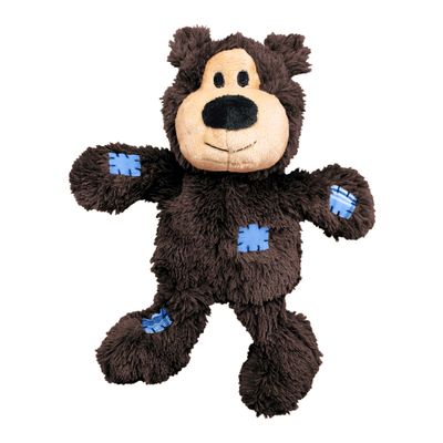 Plüschbär in Braun mit beigem Gesicht und blauen Flicken an Armen, Bein und Bauch.
