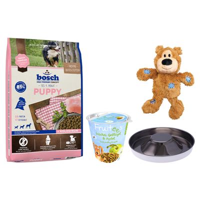 bosch Maxi Junior hundefoder, bosch Fruitees mit Apfel godbidder, brun bamse-legetøj, sort foderskål og orange cirkel med teksten 'Prøv nu!'.