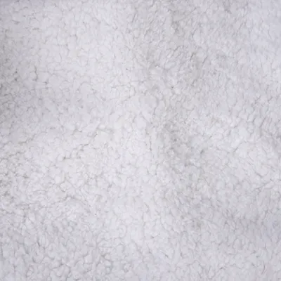 Close-up of white, soft plush material, suitable for pet products such as beds or blankets.