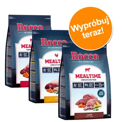 Trzy opakowania karmy Rocco Mealtime Complete Dog Food: Chicken i Lamb, widoczne napisy Grain Free Recipe, 70% Animal Ingredients. Pomarańczowe koło z tekstem: Wypróbuj teraz!