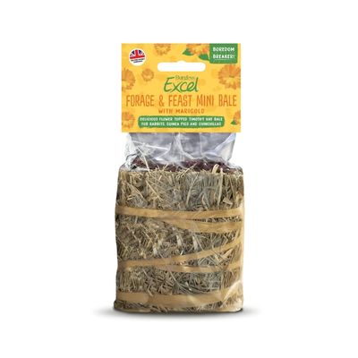 Two rabbits are eating together from a round hay bale with dried herbs on a plate.
