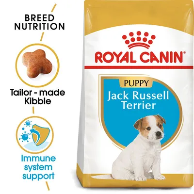 ROYAL CANIN Puppy Jack Russell Terrier dry food pack, text: Breed Nutrition, Tailor-made Kibble, Immune system support. Image of kibble piece and shield icon with blue germs. ROYAL CANIN Puppy Jack Russell Terrier dry food pack, text: Breed Nutrition, Tailor-made Kibble, Immune system support. Image of kibble piece and shield icon with blue germs.