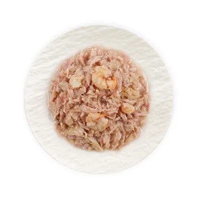 Gros plan sur de la viande hachée et des crevettes sur une assiette blanche, présenté comme contenu du produit.