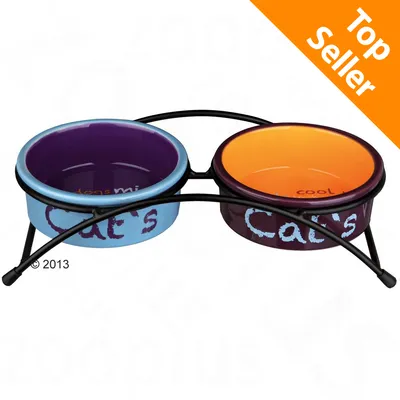 Doppia ciotola in ceramica con supporto in metallo, scritta visibile: Cat's. Etichetta arancione in alto a destra con testo: Top Seller.