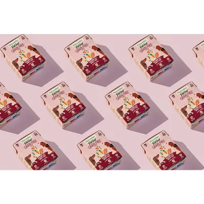 Multiple boxes of grain-free pet food with visible text highlighting 'grain free' and images of vegetables and animals on the packaging.