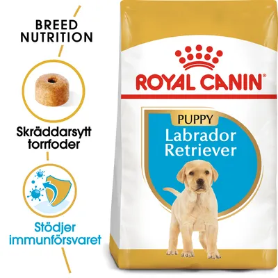 Royal Canin Puppy Labrador Retriever torrfoder, text: Skräddarsytt torrfoder, Stödjer immunförsvaret, bild på foderbit och hundvalp