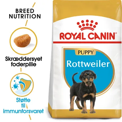 Royal Canin Puppy Rottweiler tørfoder, tekst: Breed Nutrition, Skræddersyet foderpille, Støtte til immunforsvaret. Billede af foderpille og Rottweiler-hvalp på posen.
