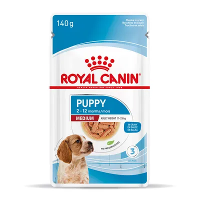 Royal Canin Puppy Medium 140 g, 2–12 months, poids adulte 11–25 kg, bouchées en sauce, sans conservateurs, photo d’un chiot et croquettes visibles sur l’emballage.