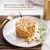 Text: Delicious cake for your cat to savour every bite. Image shows a round portion of cat food on a plate with herbs and a gold fork in the background.