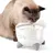 Trinkbrunnen in Katzenform mit fliessendem Wasser, Katze trinkt daraus.
