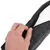 Close-up of a hand opening a zip on a cushion. Shows removable cover made of fabric and faux leather.