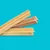 Three ridged, stick-shaped chews in different shades displayed on a blue background, showing product shape and texture.