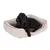 Cama rectangular beige para perros con borde elevado y cojín interior marrón, perro negro de tamaño mediano tumbado encima. Material textil visible en toda la cama.