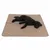 Black dog lying on a beige padded mat with quilted pattern. Small brand label visible in the corner.