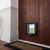 Chatière SureFlap en plastique installée sur une porte en bois, avec volet transparent et cadre noir visible en bas de la porte.