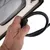 Hand holding a black spiral cable with connector plug, close-up of a product.