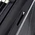 Close-up of a black plastic handle with ventilation slots, part of a transport box or cage.