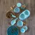 Feeding bowl set with blue pattern, includes feeding spoon, dry food container, treat jar and anti-gulp bowl. Ideal for feeding pets.