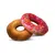 Zwei Donut-förmige Hundespielzeuge aus Stoff, eines braun und eines pink mit bunten Streuseln.