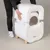 kooa cat litter box with removable lid, white, on wooden legs. Person demonstrates easy assembly by lifting the top part.