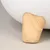 Wooden leg of a white piece of furniture, smoothly sanded with visible grain.