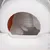 Automatic cat toilet with grey litter falling into the collection tray. Visible are a white housing and an orange filter insert.