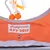 Orangefarbene Spielzeugtasche mit Schriftzug 'Catifornia AFP 2012' und hängenden Bändern mit orangefarbenen Kugeln.