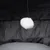 White plush ball on a black string, part of a toy or accessory for pets.