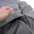 Close-up of a grey dog bed with removable cover, zip and soft fleece interior.