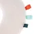 Soft, white plush material with coloured loops in orange, turquoise and dark green. Close-up of a toy or accessory.