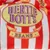 Bertie Bott's Beans. Rayas rojas y blancas con logotipo ovalado amarillo y letras moradas.