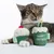 Plush toy in cupcake shape with Zooplus logo, one with red cherry and one with 'Happy Birthday' inscription. Cat in background.