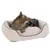 Brown tabby cat lying in a beige, padded pet bed with dark edging.